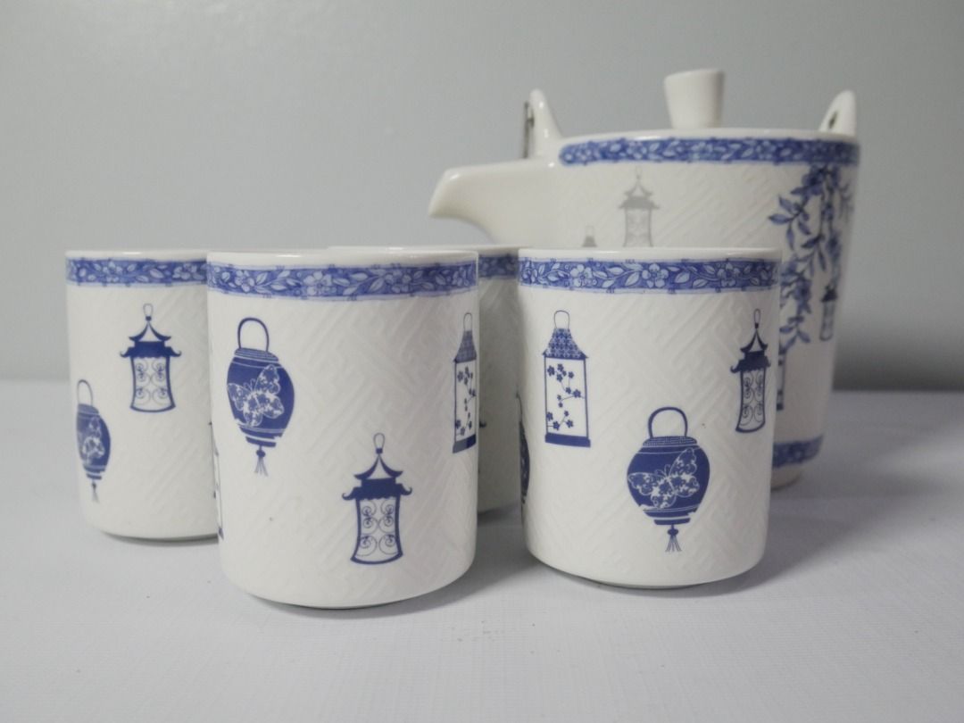 Blue & White Tea Set – Teapot with 4 Cups (Category: Coffee & Tea Tableware) located in Pasig City. Submitted by rehome.studio (Listing ID 1467097457, Image 1). Description: A charming blue and white tea set featuring delicate lantern, bird, and floral motifs. The textured finish and coordinating floral borders give it a classic, decorative look. Details: ✔ Includes 1 teapot with metal handle and infuser ✔ Includes 4 matching cups ✔ Blue and whit