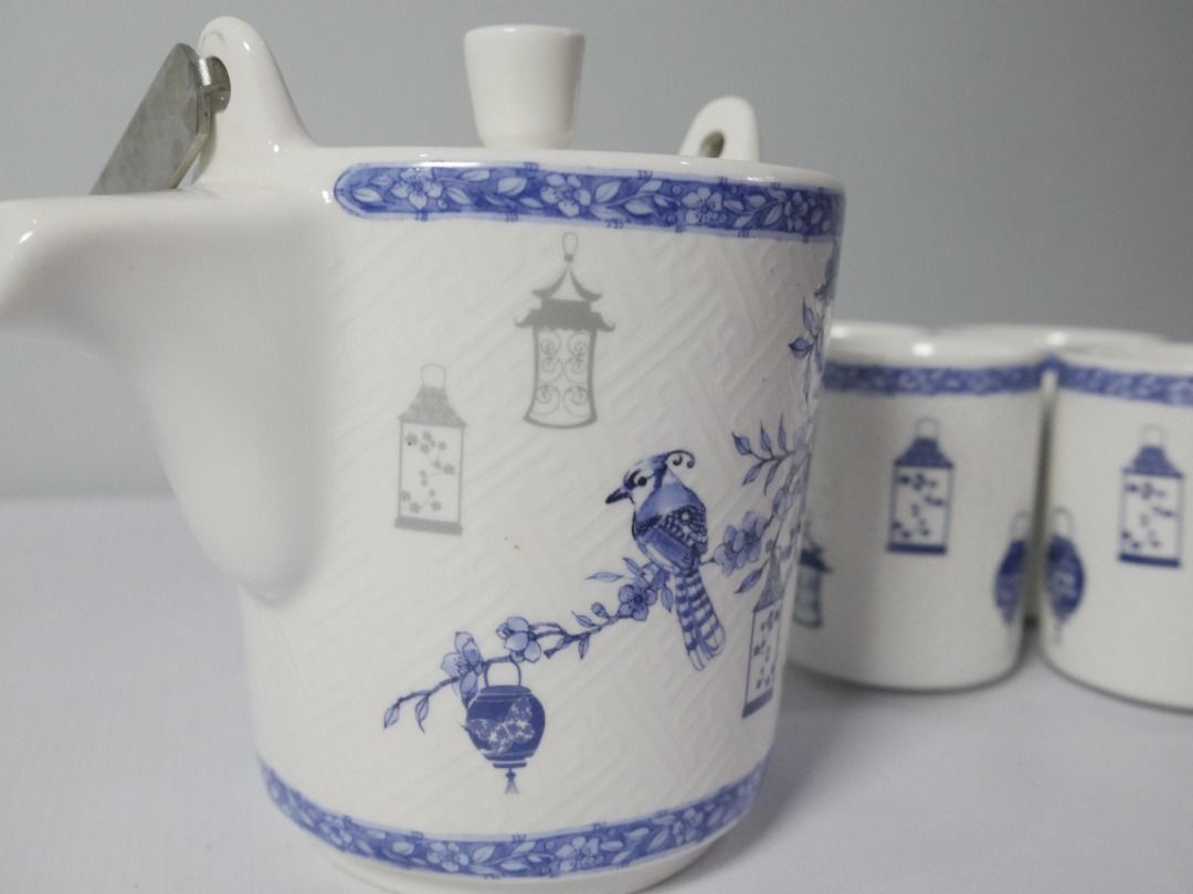 Blue & White Tea Set – Teapot with 4 Cups (Category: Coffee & Tea Tableware) located in Pasig City. Submitted by rehome.studio (Listing ID 1467097457, Image 2). Description: A charming blue and white tea set featuring delicate lantern, bird, and floral motifs. The textured finish and coordinating floral borders give it a classic, decorative look. Details: ✔ Includes 1 teapot with metal handle and infuser ✔ Includes 4 matching cups ✔ Blue and whit
