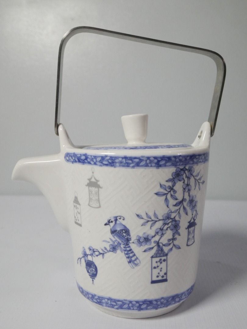 Blue & White Tea Set – Teapot with 4 Cups (Category: Coffee & Tea Tableware) located in Pasig City. Submitted by rehome.studio (Listing ID 1467097457, Image 3). Description: A charming blue and white tea set featuring delicate lantern, bird, and floral motifs. The textured finish and coordinating floral borders give it a classic, decorative look. Details: ✔ Includes 1 teapot with metal handle and infuser ✔ Includes 4 matching cups ✔ Blue and whit