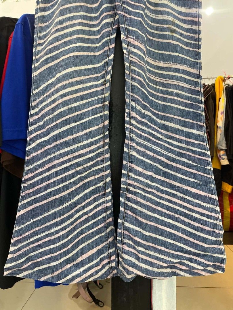 Blue and pink striped denim flared jeans (Category: Jeans) located in Cainta. Submitted by riszizlux (Listing ID 1467069374, Image 3). Description: - Style: Streetwear statement flared jeans - Pattern: Eye-catching diagonal white and pink stripes on blue denim - Features: Standard front and back pockets, button and zip closure - Fit: Flared leg cut - Condition: Excellent, ready to wear - Note: Check tape label on waistband for size details (Messa