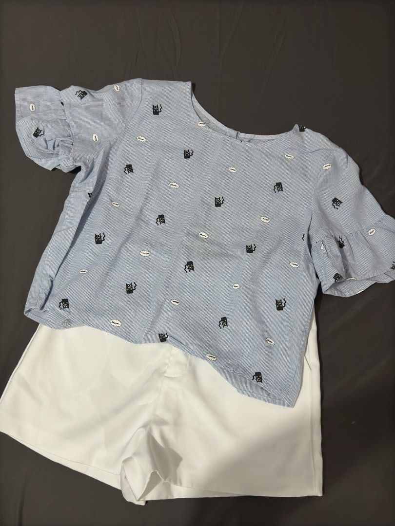 Blue Cat Print Blouse (Category: Sets or Coordinates) located in Manila. Submitted by cleverturtle.1ace8b (Listing ID 1467086029, Image 1). Description: - Blouse details: All-over black cat and speech bubble pattern, tiered ruffle cuffs, and button-down back closure - Fabric: Light and breezy, perfect for warm PH weather - Style: Casual, cute, and versatile for daily wear or weekend lakads - Condition: Brand new / Excellent quality - Mode of Paym