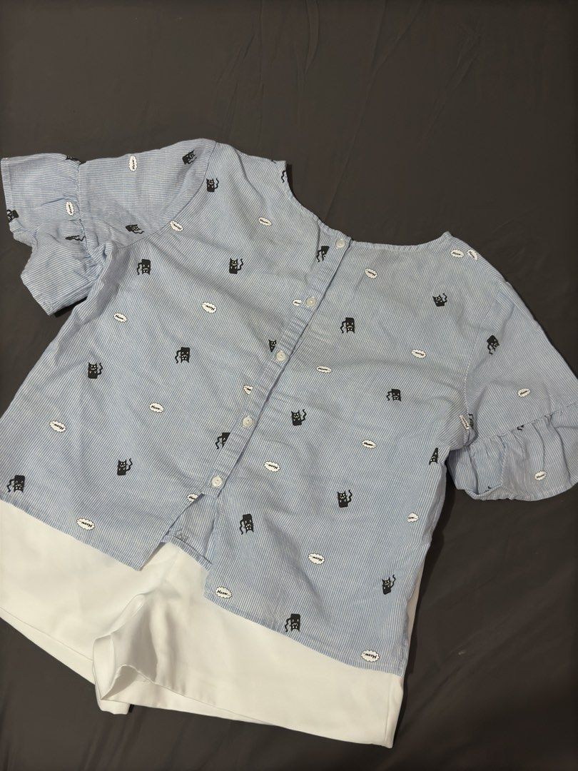 Blue Cat Print Blouse (Category: Sets or Coordinates) located in Manila. Submitted by cleverturtle.1ace8b (Listing ID 1467086029, Image 2). Description: - Blouse details: All-over black cat and speech bubble pattern, tiered ruffle cuffs, and button-down back closure - Fabric: Light and breezy, perfect for warm PH weather - Style: Casual, cute, and versatile for daily wear or weekend lakads - Condition: Brand new / Excellent quality - Mode of Paym