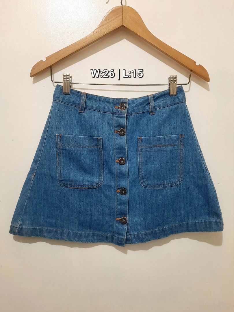 Blue Denim Front Button Mini Skirt W26 L15 (Category: Skirts) located in Cavite. Submitted by YANAminicloset (Listing ID 1467167262, Image 1). Description: - Style: Blue denim mini skirt with front button-up closure - Details: Contrast orange topstitching and two front patch pockets - Fit: Waist measures 26 inches, length is 15 inches - Extras: Includes waistband belt loops - Condition: Excellent, ready to wear!.