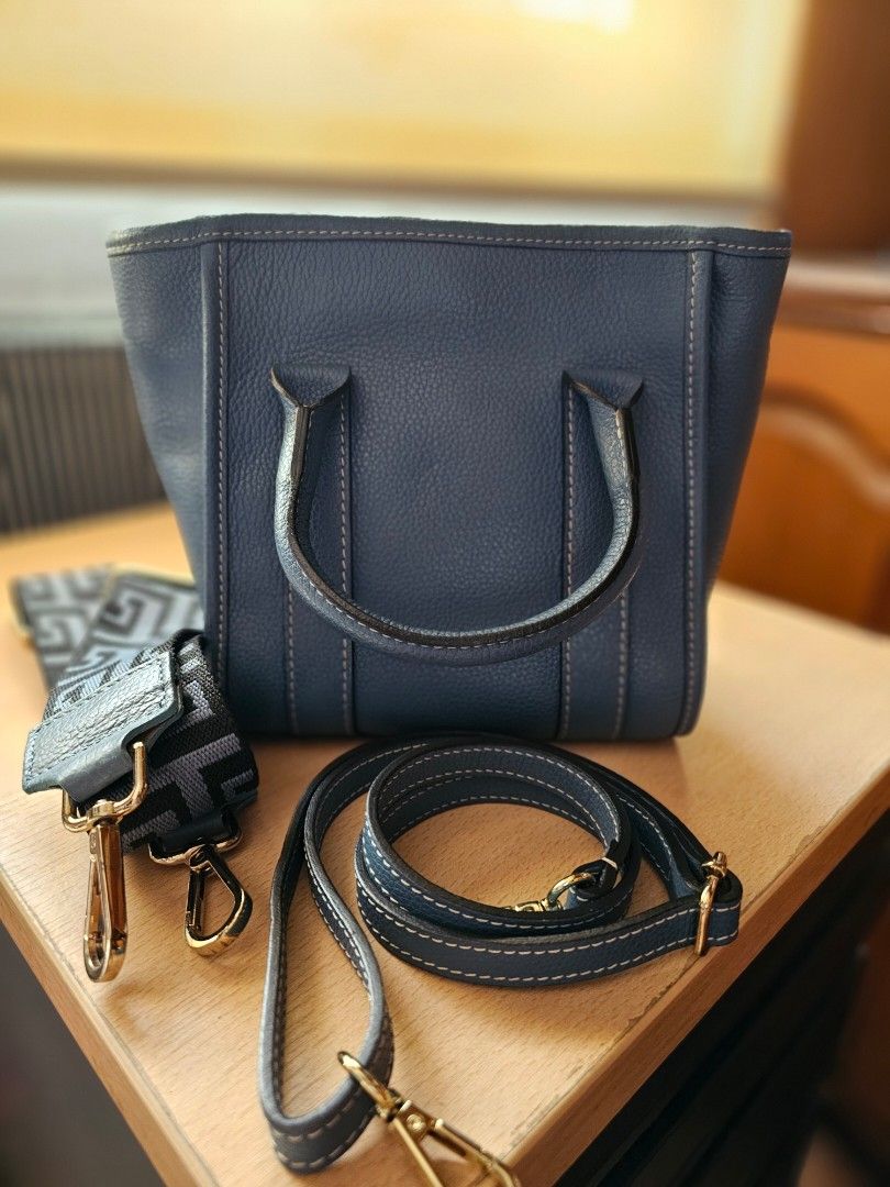 Blue Leather Tote Bag with Shoulder Straps (Category: Tote Bags) located in Muntinlupa City. Submitted by ninja_mode2323 (Listing ID 1466982501, Image 1). Description: - Blue textured leather tote bag. Soft pebbled leather. - Compact everyday size: approx. 22 cm (L) x 10 cm (W) x 18 cm (H) - Includes 2 interchangeable straps: matching leather and trendy patterned fabric - Elegant gold-tone hardware with protective metal feet on the bottom - Secur