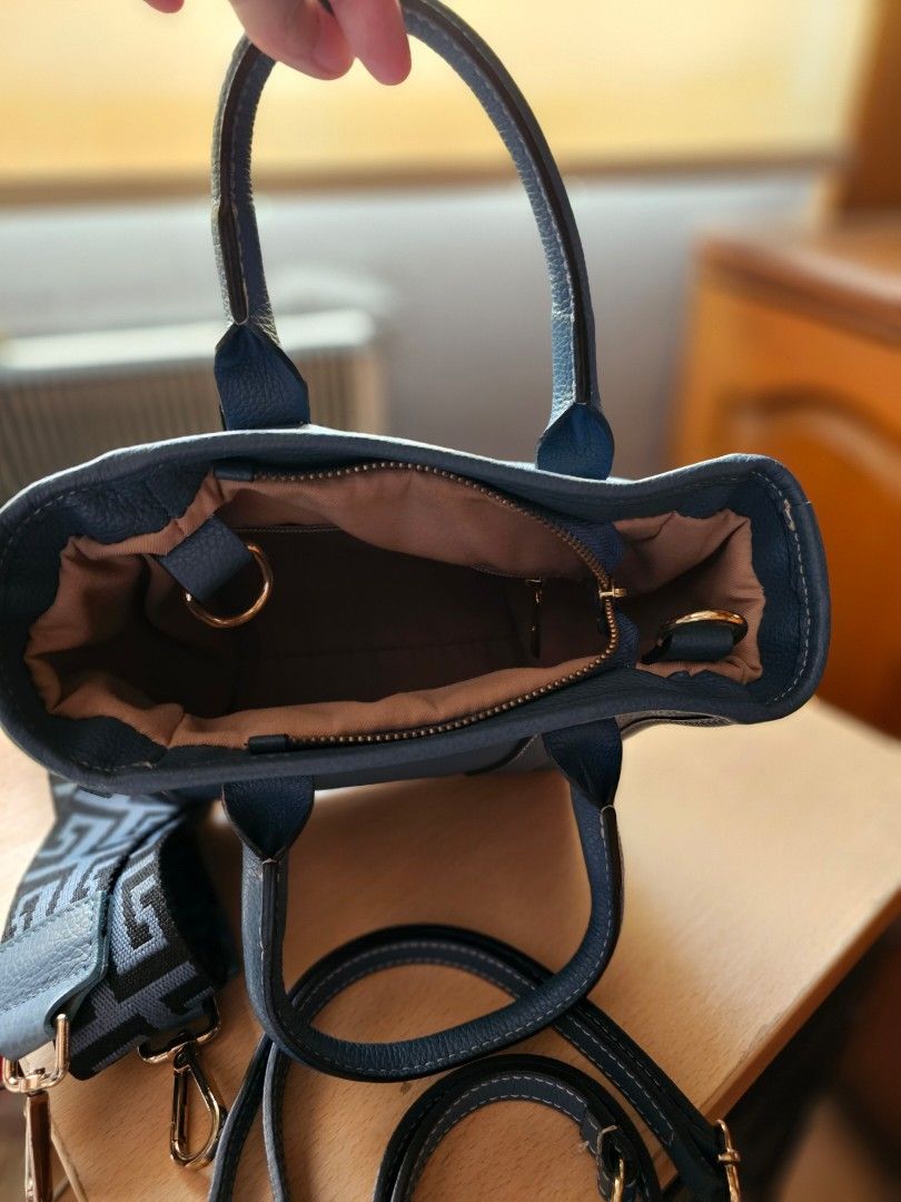 Blue Leather Tote Bag with Shoulder Straps (Category: Tote Bags) located in Muntinlupa City. Submitted by ninja_mode2323 (Listing ID 1466982501, Image 2). Description: - Blue textured leather tote bag. Soft pebbled leather. - Compact everyday size: approx. 22 cm (L) x 10 cm (W) x 18 cm (H) - Includes 2 interchangeable straps: matching leather and trendy patterned fabric - Elegant gold-tone hardware with protective metal feet on the bottom - Secur