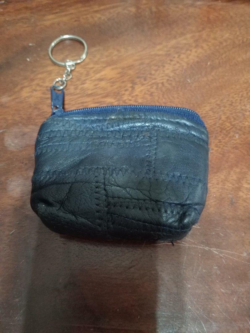 Blue patchwork leather coin purse with keychain (Category: Purses & Pouches) located in Makati City. Submitted by YSL80022 (Listing ID 1467033432, Image 1). Description: - Color: Blue - Material: Genuine leather with unique patchwork texture and visible zigzag stitching - Secure zipper closure with an attached metal key ring - Compact and pocket-friendly size - Clean black fabric interior lining - Perfect for coins, keys, and small essentials.
