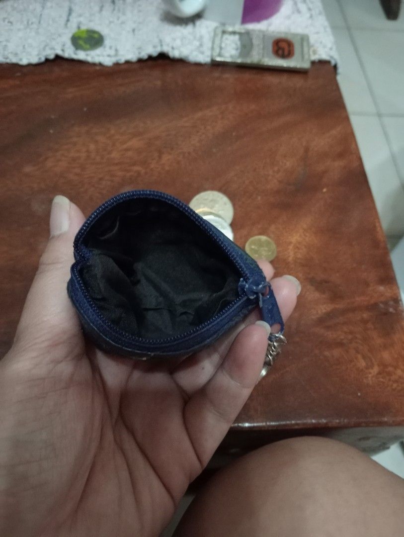 Blue patchwork leather coin purse with keychain (Category: Purses & Pouches) located in Makati City. Submitted by YSL80022 (Listing ID 1467033432, Image 3). Description: - Color: Blue - Material: Genuine leather with unique patchwork texture and visible zigzag stitching - Secure zipper closure with an attached metal key ring - Compact and pocket-friendly size - Clean black fabric interior lining - Perfect for coins, keys, and small essentials.