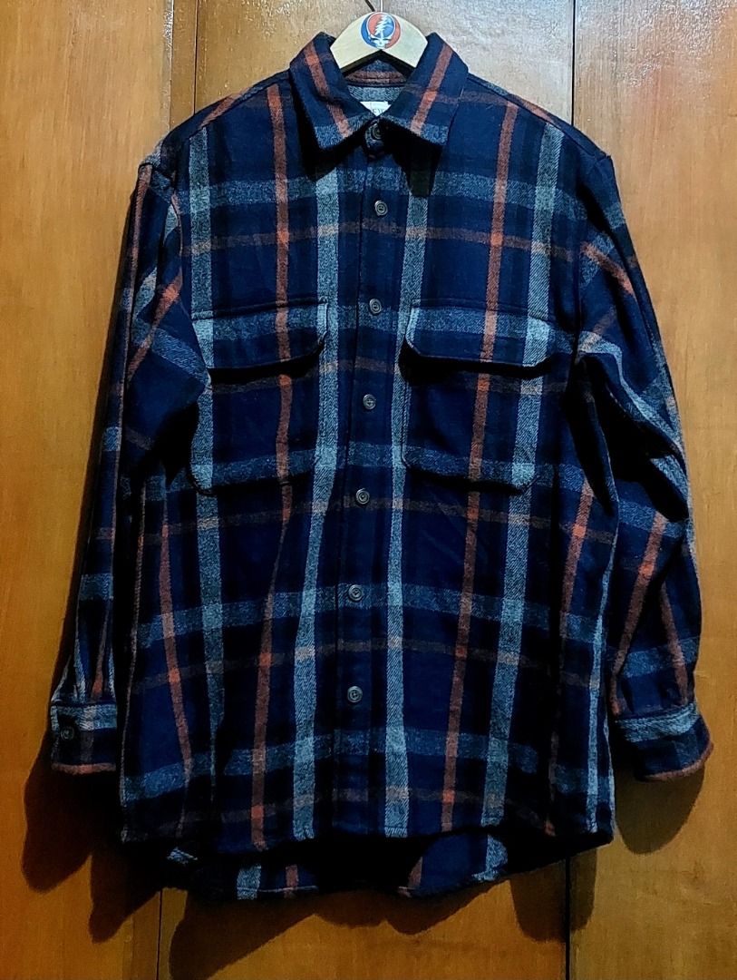 Blue Plaid Flannel Button-Down Shirt with Pockets (Category: Longsleeves) located in Legazpi City. Submitted by street_uniform (Listing ID 1467157840, Image 1). Description: - Dimes: W24 L29 - Color: Navy blue with grey and orange plaid pattern - Material: Soft, heavyweight flannel great for cold weather layering - Features: Two front chest pockets with button flaps - Closure & Cuffs: Button-down front and buttoned cuffs - Fit: Standard fit for e