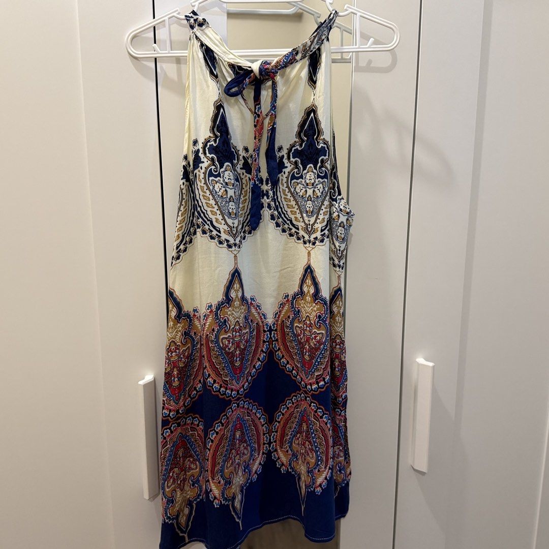 Boho Paisley Print Halter Dress (Category: Dresses) located in Marikina City. Submitted by lovegoeson (Listing ID 1467140370, Image 2). Description: - Style: Boho halter dress with a cute tie-neck closure - Print: Intricate paisley in blue, cream, and red tones - Length: Hits around knee-length - Material: Lightweight and flowy, ideal for warm weather or beach trips.