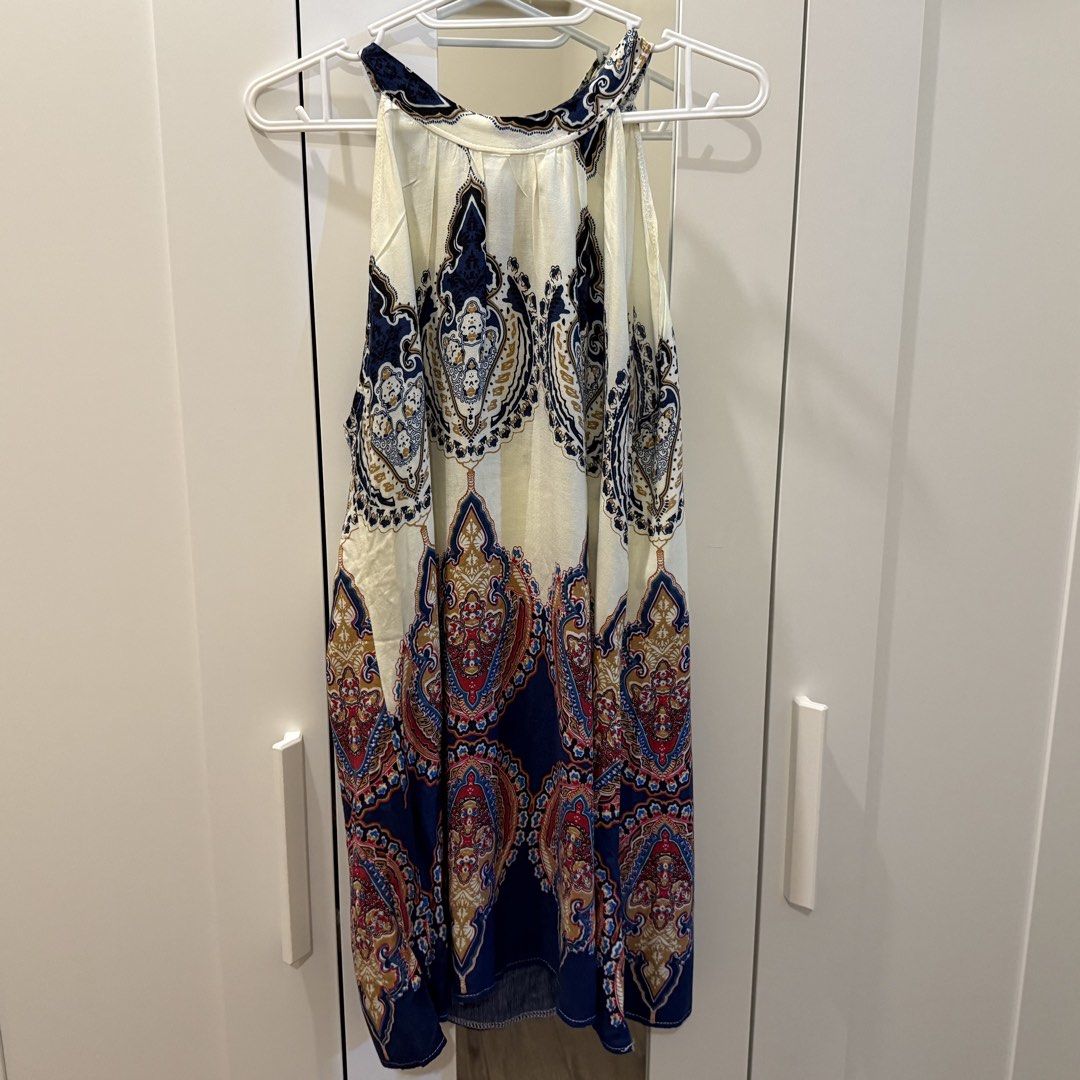 Boho Paisley Print Halter Dress (Category: Dresses) located in Marikina City. Submitted by lovegoeson (Listing ID 1467140370, Image 1). Description: - Style: Boho halter dress with a cute tie-neck closure - Print: Intricate paisley in blue, cream, and red tones - Length: Hits around knee-length - Material: Lightweight and flowy, ideal for warm weather or beach trips.