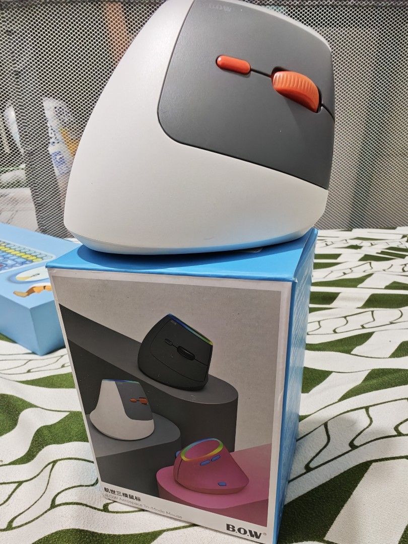 B.O.W MD470BL Aerospace Tri-Mode Mouse (Category: Mouse & Mousepads) located in Imus. Submitted by jamillabrillantes (Listing ID 1466991719, Image 2). Description: - Brand: B.O.W aerospace tri-mode mouse - Color: White and grey with vibrant RGB light strip and stylish orange scroll wheel/buttons - Connectivity: Tri-mode options located conveniently on the underside - Condition: Brand new, never used, with original protective plastic film still on