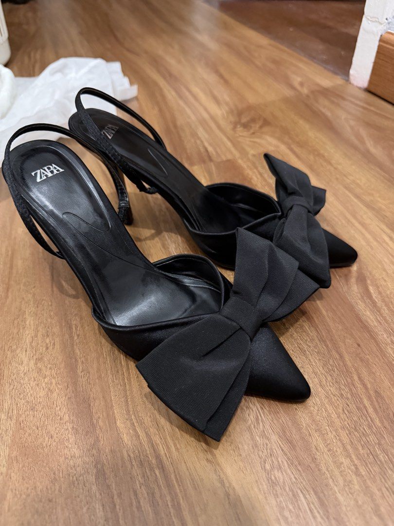 Zara Black Bow Slingback Heels (Category: Heels) located in Manila. Submitted by tvntdd (Listing ID 1467036731, Image 1). Description: - Brand: Zara - Style: Black satin slingback stiletto heels with pointed toe and large statement bow - Size: 37 EU - Condition: Excellent - Inclusion: Original Zara dust bag - Perfect for: Date nights, parties, and formal occasions.