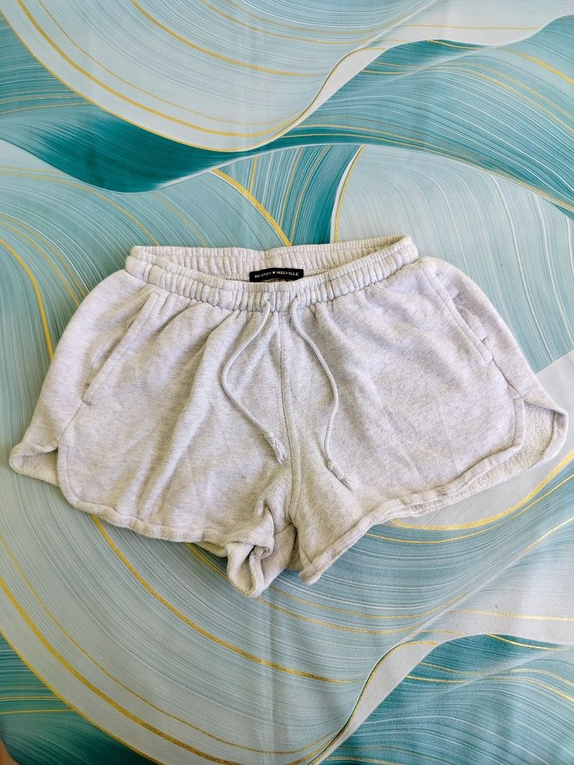 Brandy Melville Light Grey Sweat Shorts (Category: Shorts) located in Manila. Submitted by virgiliosa38485 (Listing ID 1467112650, Image 1). Description: - Brand: Brandy Melville -Waist 22-32 - Color: Light grey - Model number: MR212D-Z094 (Tag attached) - Material: Soft fleece-lined interior - Waistband: Elastic with adjustable drawstring ties - Features: Convenient side pockets and relaxed fit with curved hems - Condition: Brand new with tags.