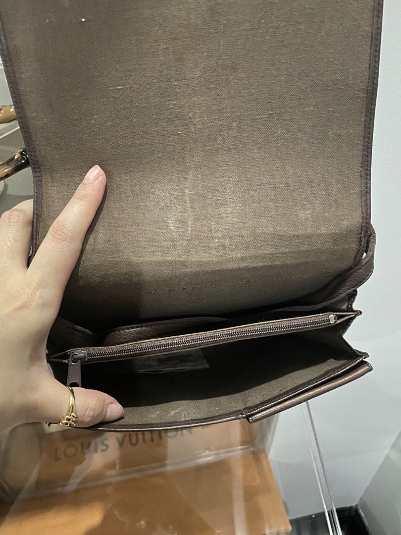 Brown leather shoulder bag with multiple card slots (Category: Shoulder Bags) located in Manila. Submitted by escherichiaa (Listing ID 1467098219, Image 3). Description: - Color & Material: Dark brown leather - Style: Structured shoulder bag with flap and snap button closure - Interior Organization: Multiple card slots, one slip pocket, and one zipped compartment - Condition: Clean lining with minor wear marks - Size: Compact, perfect for daily e