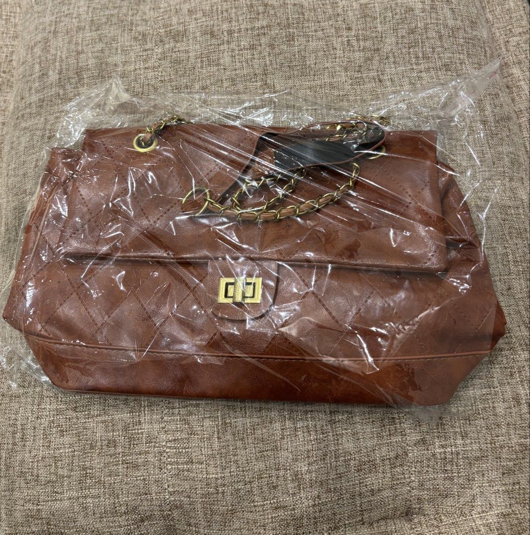 Brown Quilted Shoulder Bag with Gold Chain (Category: Shoulder Bags) located in Makati City. Submitted by bittersweet818ta (Listing ID 1467133887, Image 3). Description: - Color: Brown - Material: Quilted design with dark brown fabric lining - Straps: Gold chain straps with comfortable leather shoulder guards - Closure: Flap top with a secure rectangular twist lock - Interior: Main compartment divided by a convenient zip pocket - Protection: Stru