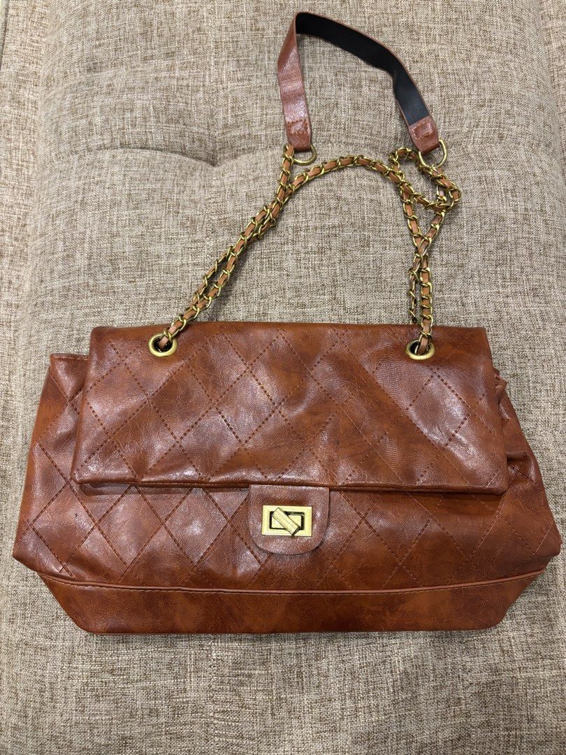 Brown Quilted Shoulder Bag with Gold Chain (Category: Shoulder Bags) located in Makati City. Submitted by bittersweet818ta (Listing ID 1467133887, Image 1). Description: - Color: Brown - Material: Quilted design with dark brown fabric lining - Straps: Gold chain straps with comfortable leather shoulder guards - Closure: Flap top with a secure rectangular twist lock - Interior: Main compartment divided by a convenient zip pocket - Protection: Stru