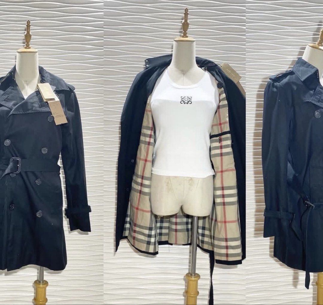 Burberry Black Trench Coat with Check Lining (Category: Coats, Jackets and Outerwear) located in Bacolod City. Submitted by bhabissagal-05763 (Listing ID 1466994782, Image 1). Description: - Brand new with tags still attached - Classic black trench coat with iconic beige check lining - Double-breasted front with tortoiseshell-effect engraved buttons - Includes a matching waist belt and adjustable buckled cuffs - Mid-length cut, ideal staple piece