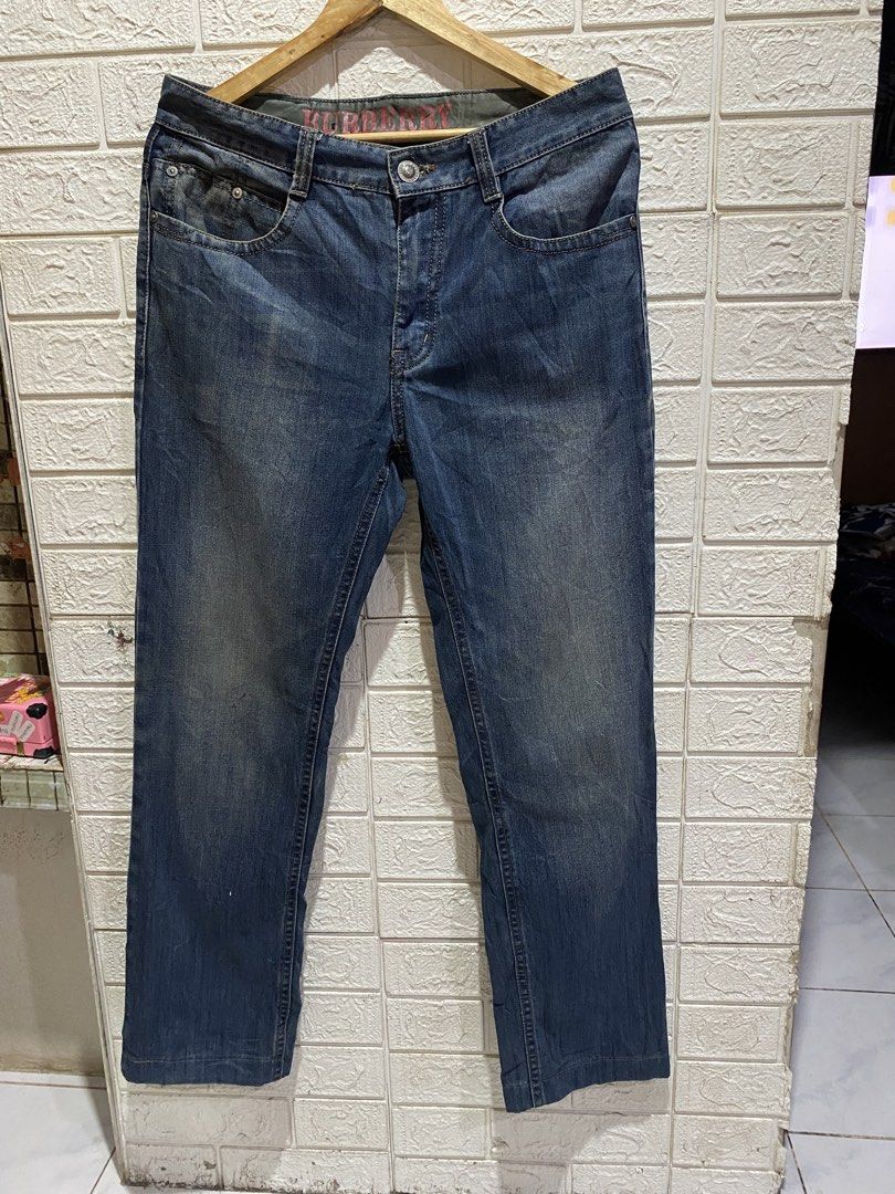 Burberry Blue Denim Jeans Size 34 (Category: Jeans) located in Rizal. Submitted by tiangarcia02 (Listing ID 1467115017, Image 1). Description: - Brand: Burberry - Size: 34 - Fit: Classic straight fit - Wash: Dark wash with stylish fading on front and back - Details: Branded back pockets, leather back patch with metal equestrian knight logo, and interior red Burberry waistband lining - Condition: Care tag and size label attached inside.
