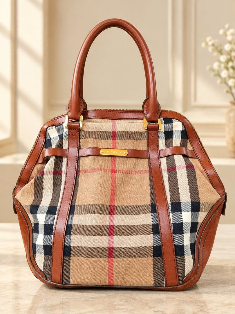Burberry Brown leather camel check Large (Category: Luxury Bags & Wallets) located in Lucena. Submitted by amirahsoonlineshop (Listing ID 1466175370, Image 1). Description: - Authentic Burberry check canvas tote bag - Features classic tan leather trim and dual top handles - Elegant gold-tone hardware with embossed Burberry metal bar - Secure zip-top closure with dark fabric lining and interior leather tag - Made in Italy - Condition: Normal wear 