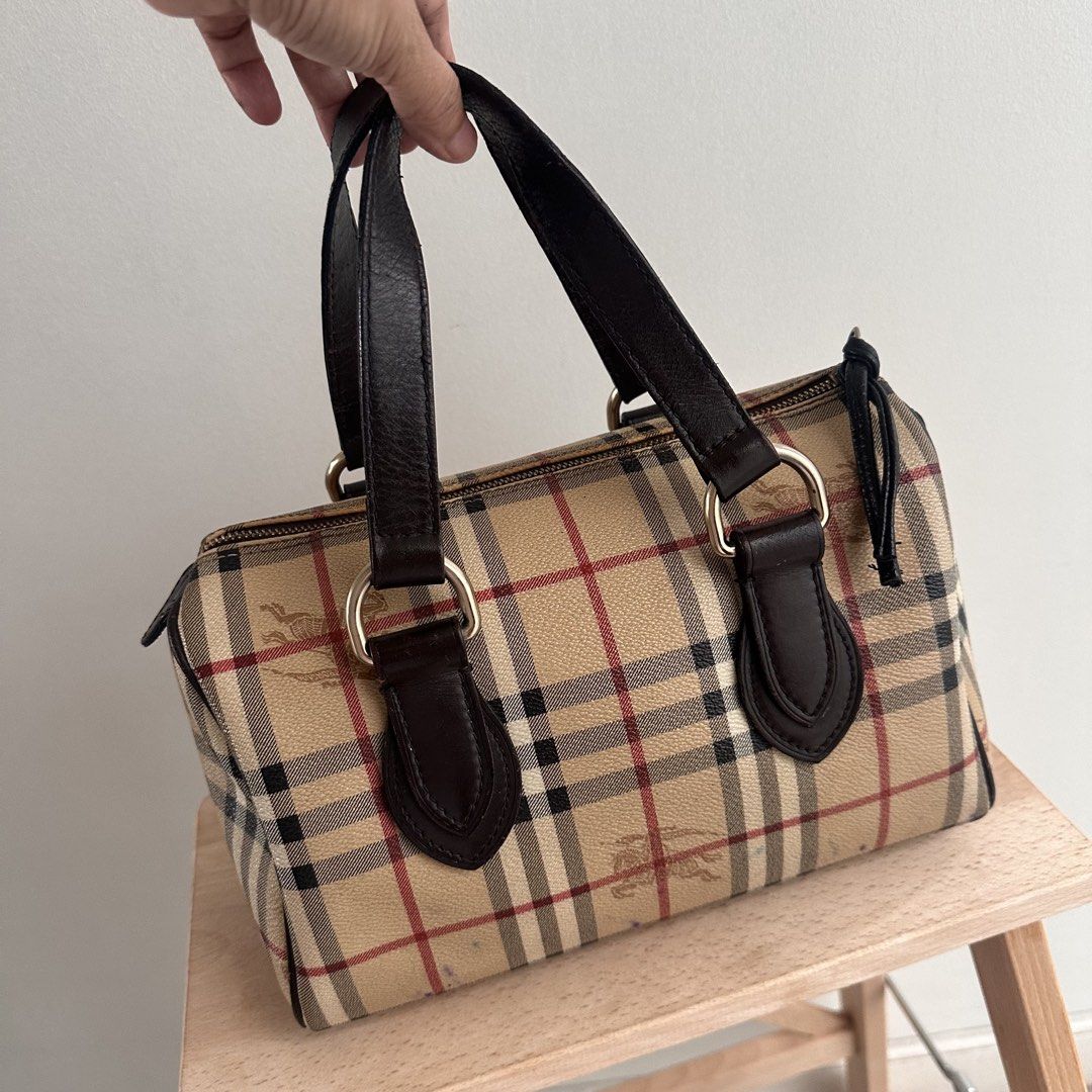 Burberry Vintage Nova Check Barrel Handbag (Category: Luxury Bags & Wallets) located in Paranaque City. Submitted by closetmalou (Listing ID 1467120888, Image 2). Description: Vintage Burberry Check Bowling Bag Classic beige Burberry check pattern with dark brown leather handles and trim, gold-tone hardware, and a zip-top closure. Features a spacious interior for everyday essentials. Measurements: * Width: 11 inches * Height: 8 inches * Depth: 6 