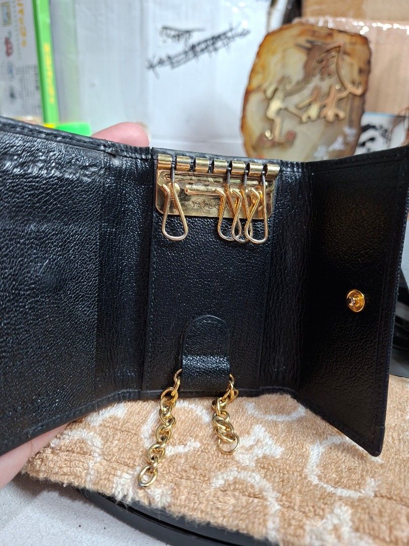 Bvlgari Black Leather 6-Hook Key Case (Category: Luxury Bags & Wallets) located in Lucena. Submitted by dai_suki (Listing ID 1466980638, Image 2). Description: - Brand: Bvlgari - Material: Black textured leather with gold-tone hardware - Design: Front flap with double BVLGARI pa rings - Interior: 6 key hooks and a side chain attachment - Closure: Secure snap button (fully functional) - Condition: Minor handling signs, light edge wear, and standar