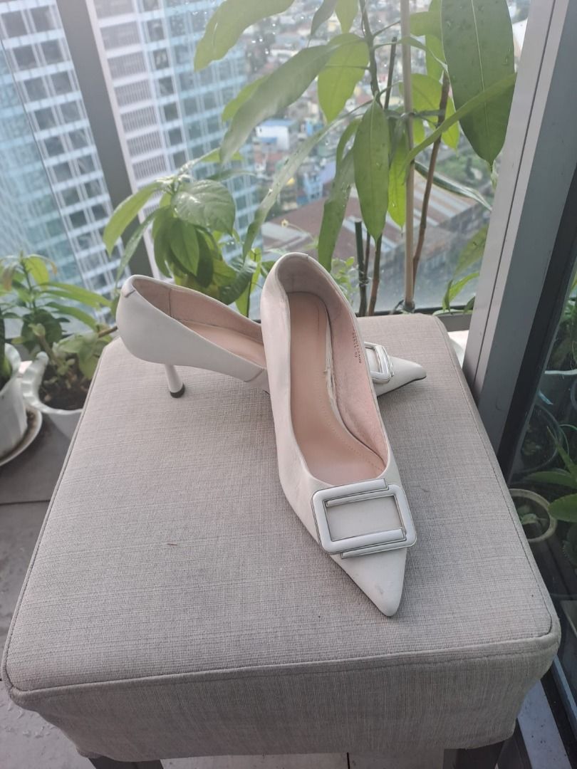 c banner pointed heels (Category: Heels) located in Mandaluyong City. Submitted by epicowl-c93c (Listing ID 1467038027, Image 1). Description: The image displays a pair of elegant, off-white pointed-toe pump heels accented with a distinct square buckle detail across the vamp. They feature a low to mid-height kitten/stiletto heel, making them versatile for both formal settings and smart-casual styling..