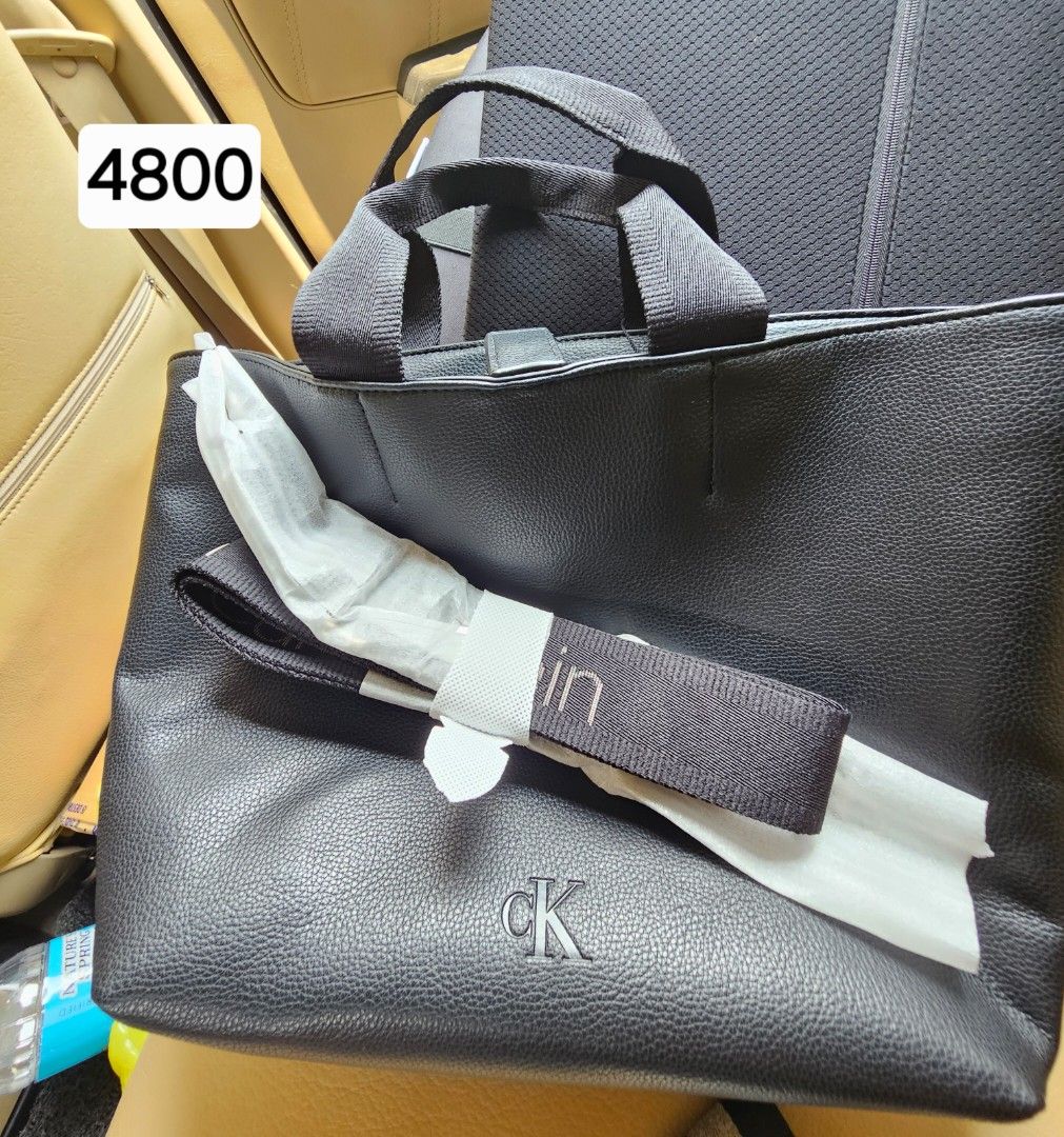 Calvin Klein Black Leather Tote Bag (Category: Tote Bags) located in Davao. Submitted by dahl957172787 (Listing ID 1459229683, Image 1). Description: - Brand: Calvin Klein - Color: Black - Material: Textured Leather - Handles: Two top handles - Strap: Detachable strap included - Interior: One zip pocket - Closure: Snap closure - Condition: Comes with original tags - Ideal for: Everyday use.