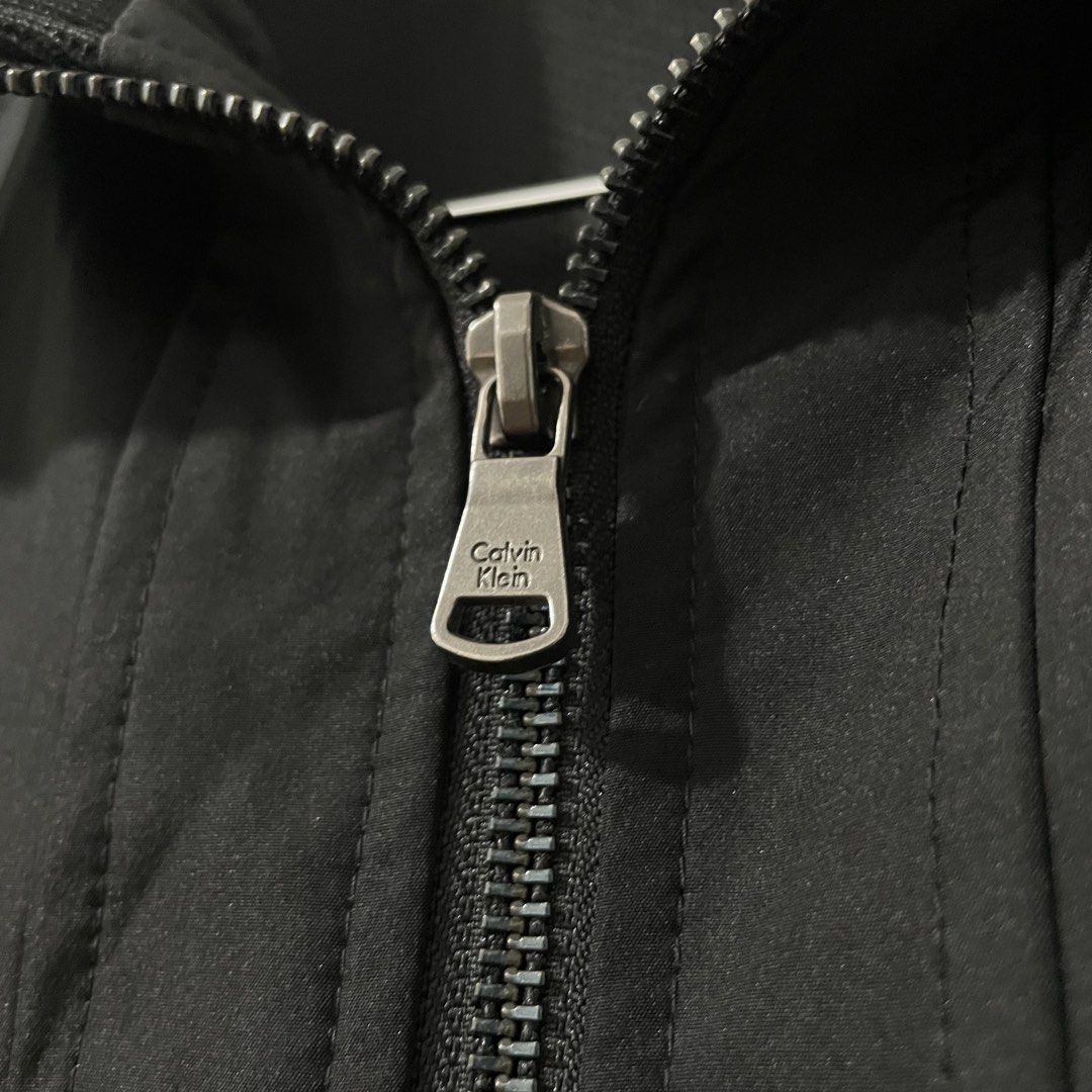 Calvin Klein Men's Zip Up Jacket (Medium) (Category: Coats, Jackets and Outerwear) located in Quezon City. Submitted by 2h3nji (Listing ID 1467013111, Image 3). Description: Calvin Klein Men's Zip Up Jacket • Medium (Can fit to Large) • 23x27 • Black • 10/10 color rate • Good as new • No issues 1,500💵 Tandang Sora, QC📍.