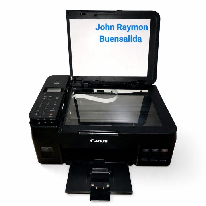 Canon All-in-One Ink Tank Printer (Category: Printers, Scanners & Copiers) located in Manila. Submitted by johnraymon.2808 (Listing ID 1467144906, Image 1). Description: - Brand: Canon Multifunction Printer - Color: Sleek All-Black Finish - Key Features: Built-in visible ink tanks on the right, fully opening scanner lid, and bottom pull-out paper tray - Control: User-friendly control panel with LCD screen and physical buttons on the left - Condit