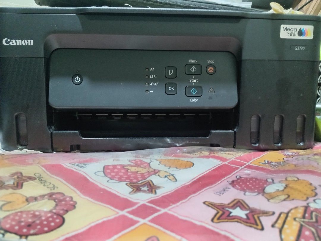 Canon PIXMA G2730 Mega Tank Printer (Category: Printers, Scanners & Copiers) located in Paranaque City. Submitted by ibengivyja87388 (Listing ID 1467091864, Image 3). Description: - Model: Canon PIXMA G2730 Mega Tank All-in-One Printer - Condition: Good working order with a clean exterior - Ink System: Continuous ink supply system with front-facing visible reservoirs for easy monitoring - Functions: Print, scan, and copy with an integrated flatbe