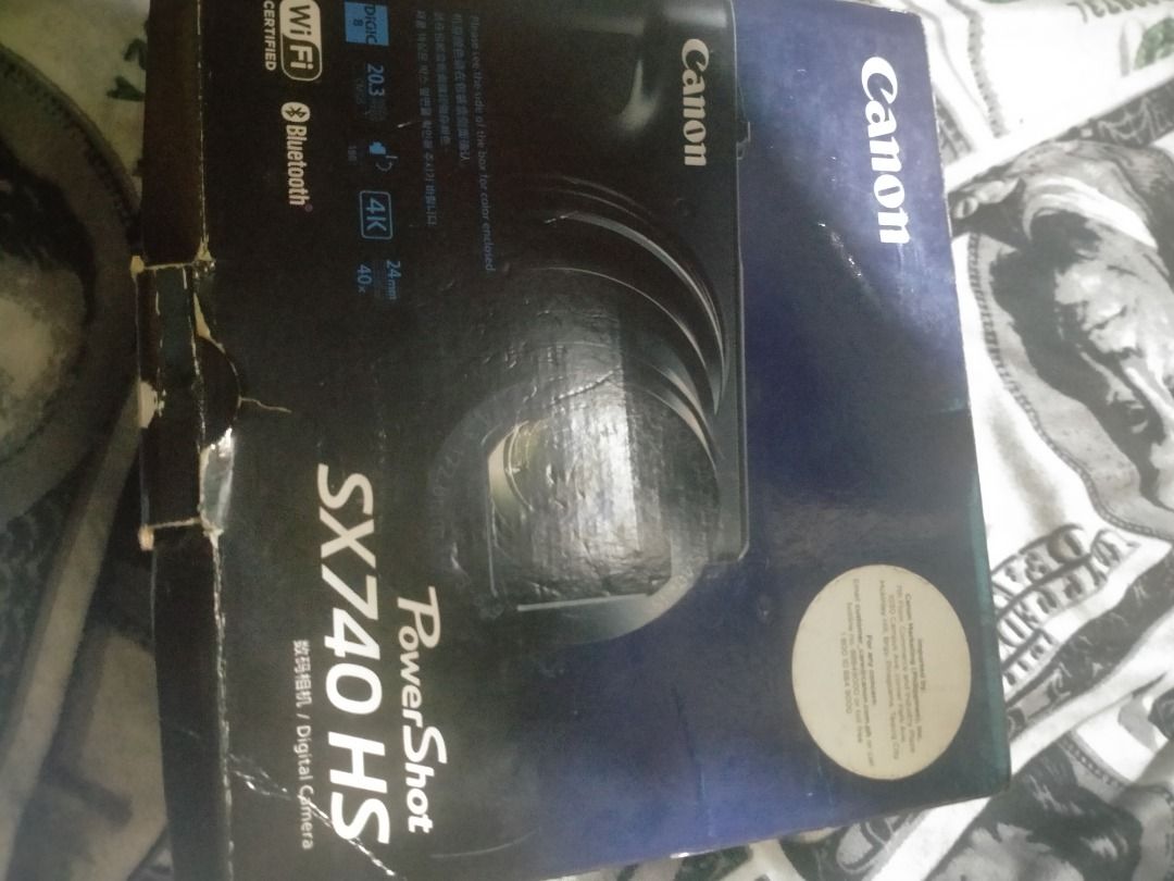 Canon PowerShot SX740 HS Digital Camera Box (Category: Cameras) located in Quezon City. Submitted by roxaschloeeex (Listing ID 1467163903, Image 1). Description: - Authentic Canon PowerShot SX740 HS empty box/packaging - Features printed specs: 20.3 Megapixels, 40x Optical Zoom, 4K Video, Wi-Fi & Bluetooth - Condition: Cardboard shows slight storage wear along edges and corners - Ideal for completing your camera set for resale or keeping your gea