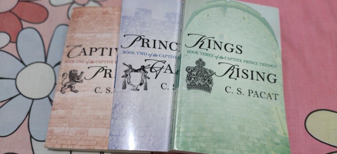 Captive Prince Trilogy Books by C.S. Pacat (Category: Storybooks) located in Cebu City. Submitted by patjl (Listing ID 1467062645, Image 1). Description: Complete Captive Prince Trilogy: Book One (Captive Prince), Book Two (Prince's Gambit), and Book Three (Kings Rising) PRICE: 3K (SOLD AS A SET!) Format: Paperback editions published by Berkley Condition: Clean, intact covers with mild page yellowing due to shelf storage. Stored inside an acrylic