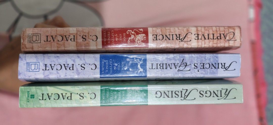 Captive Prince Trilogy Books by C.S. Pacat (Category: Storybooks) located in Cebu City. Submitted by patjl (Listing ID 1467062645, Image 2). Description: Complete Captive Prince Trilogy: Book One (Captive Prince), Book Two (Prince's Gambit), and Book Three (Kings Rising) PRICE: 3K (SOLD AS A SET!) Format: Paperback editions published by Berkley Condition: Clean, intact covers with mild page yellowing due to shelf storage. Stored inside an acrylic