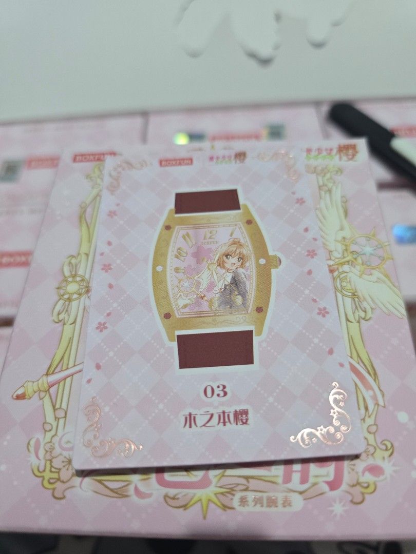 Card Captor Boxfun Series Wristwatch (Category: Raw Singles) located in Mandaluyong City. Submitted by tsukineko0613 (Listing ID 1467020021, Image 2). Description: - Series: Boxfun Cardcaptor Sakura - Card Number: 03 - Features: Kinomoto Sakura with special watch design, pink checkered background, and foil-stamped floral corners - Condition: Pack-fresh, clean corners, and crisp edges (stored immediately after pulling).