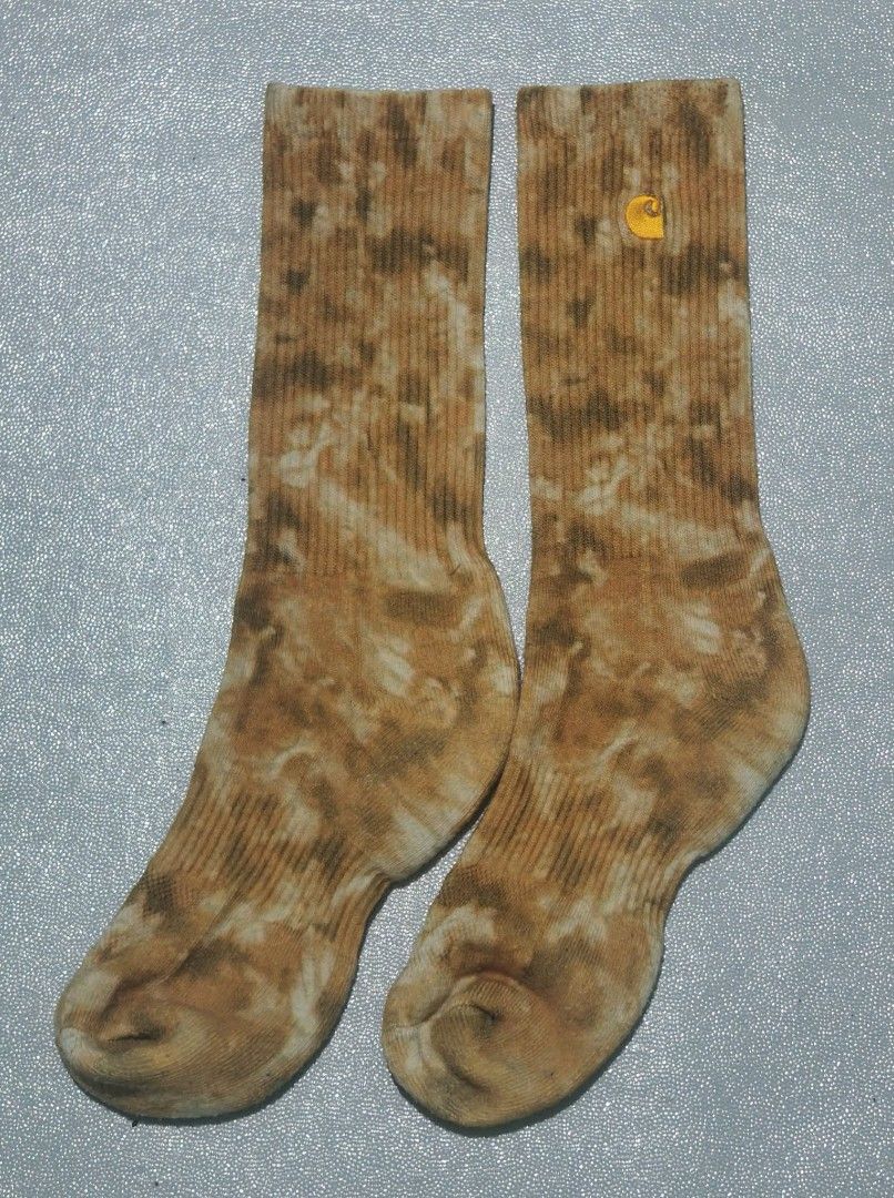 Carousell Carhartt Tie-Dye Crew Socks (Category: Socks) located in Tagum. Submitted by tripthrift2026 (Listing ID 1467025318, Image 2). Description: - Brand: Carhartt - Design: Brown and white tie-dye pattern - Details: Ribbed knit texture with embroidered logo near the cuff - Height: Standard crew - Condition: Brand new - Perfect for daily streetwear and casual fits.