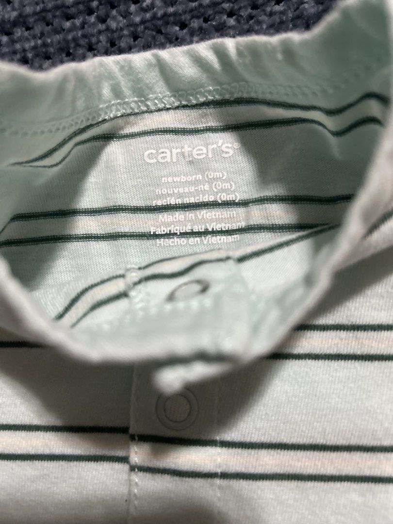 Carter's Striped Newborn Romper (Category: Babies & Kids Fashion) located in Pasig City. Submitted by mixpicks (Listing ID 1467166237, Image 3). Description: - Brand: Carter's - Size: Newborn - Design: Light blue and green stripes - Material: Soft, breathable cotton - Features: Short sleeves, front and bottom snap buttons for easy changing - Comfort: Tagless printed neckline to prevent irritation - Origin: Made in Vietnam.