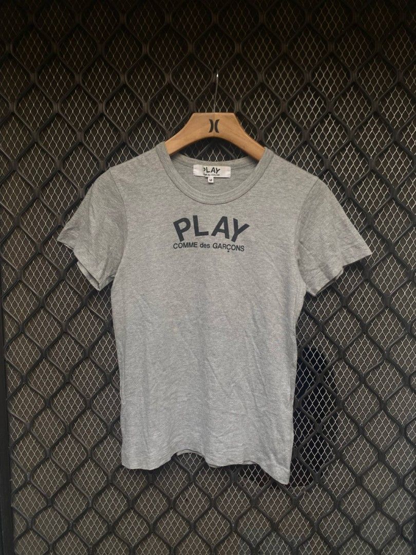 CDG Play (Category: Shirts) located in Muntinlupa City. Submitted by eksenathriftshop (Listing ID 1467097282, Image 1). Description: Good Condition Issue: Minimal Hairlines and stain (check photos) Size medium on tag.