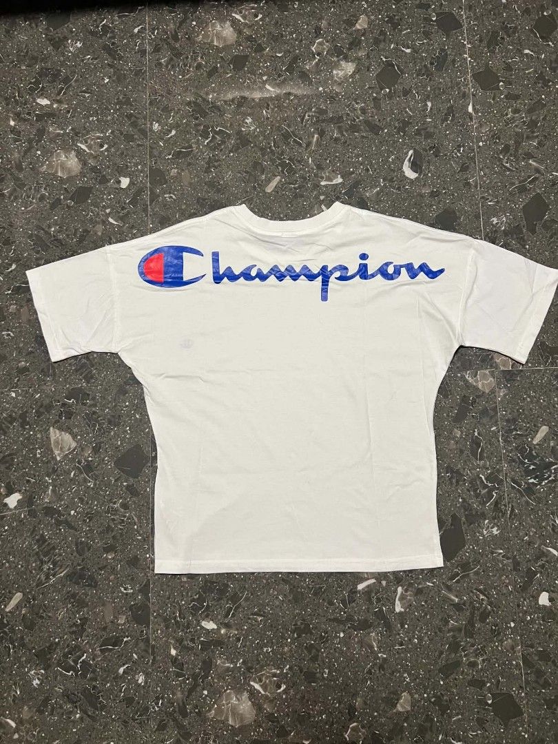 CHAMPION WHITE T-SHIRT (Category: Shirts) located in San Fernando. Submitted by _jaximus (Listing ID 1467138903, Image 2). Description: - Brand: Champion - Color: White - Size: Small - Features: Classic embroidered logo on chest and large script logo across upper back - Fit: Short sleeves with a relaxed body fit - Condition: Great casual piece with original tag intact at the collar.