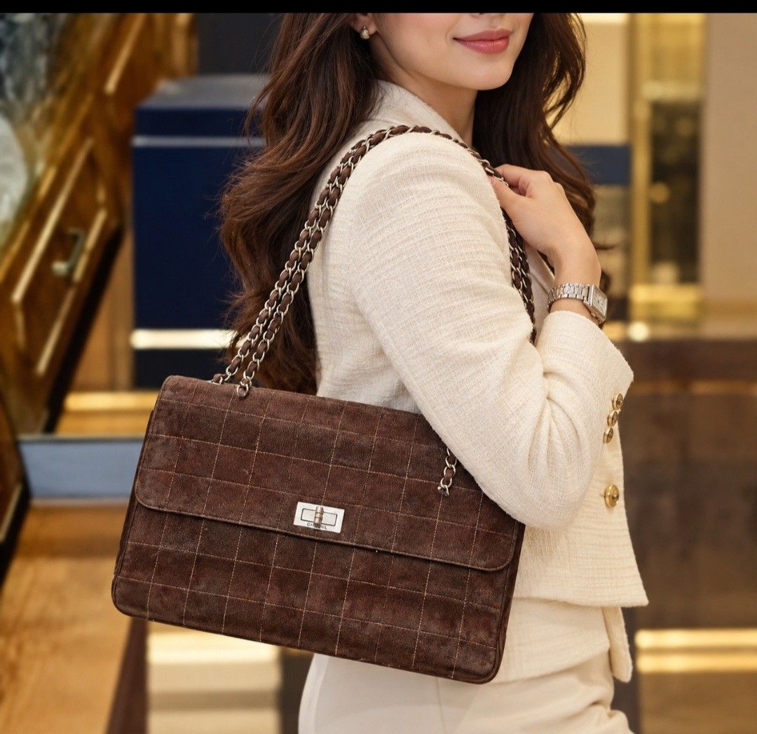 Chanel 2.55 Suede Handbag (authentic) (Category: Luxury Bags & Wallets) located in Caloocan City. Submitted by mhelcgm (Listing ID 1422427690, Image 1). Description: - Authentic Chanel 2.55 handbag - Brown suede material - Classic flap closure - Chain strap - Features custom artwork - Includes Chanel label and serial number - Made in France.