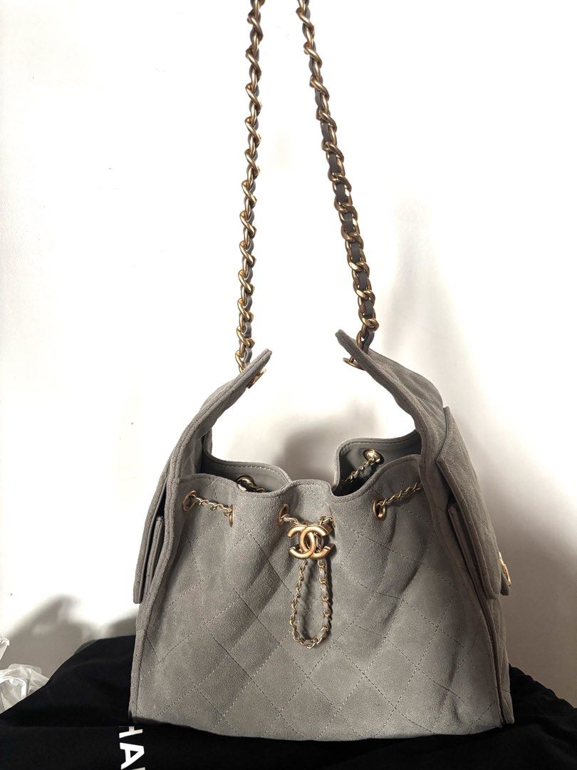 Chanel 25 Suede Bag Gold Hardware Grey (Category: Luxury Bags & Wallets) located in Navotas City. Submitted by carla.lololomo (Listing ID 1467010182, Image 2). Description: - Chanel bucket bag - Material: Quilted suede in grey - Hardware: Gold-tone chain straps and CC twist-lock closure - Interior: Dark fabric lining with wall pocket and 'Chanel Made in Italy' leather tag - Closure: Flap with magnetic snap button (Chanel Paris stamped) - Inclusio