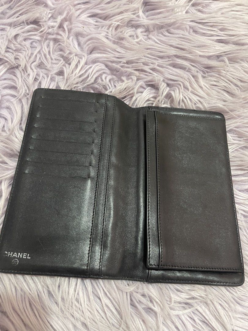 Chanel Black Quilted Long Wallet (Category: Wallets & Card holders) located in Cabanatuan. Submitted by imported2023 (Listing ID 1467103611, Image 2). Description: - Brand: Chanel - Material: Premium black quilted leather with embossed exterior lettering - Hardware: Silver-tone interlocking CC logo - Interior: Multiple card slots, cash compartments, and a zippered pocket - Lining: Beige fabric with repeating Chanel branding - Origin: Made in Ital