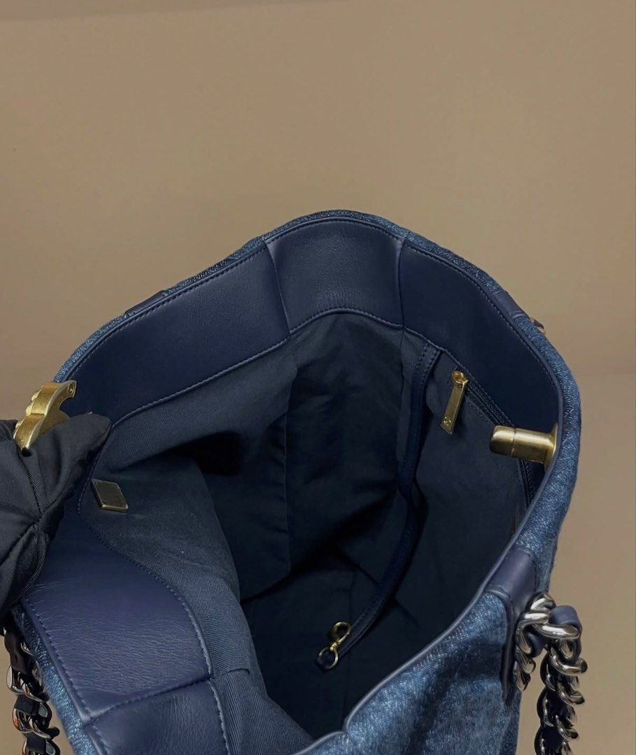 Chanel Denim Quilted Tote Bag (Category: Tote Bags) located in Makati City. Submitted by dgcurated09 (Listing ID 1467147785, Image 3). Description: - Authentic Chanel dark blue denim tote bag with chic quilted diamond pattern - Stunning mixed gold-tone and ruthenium hardware - Iconic interlocking CC turn-lock front closure - Premium dark blue leather trim on top edge and handles - Navy fabric interior featuring a zipper pocket and key leash - Int