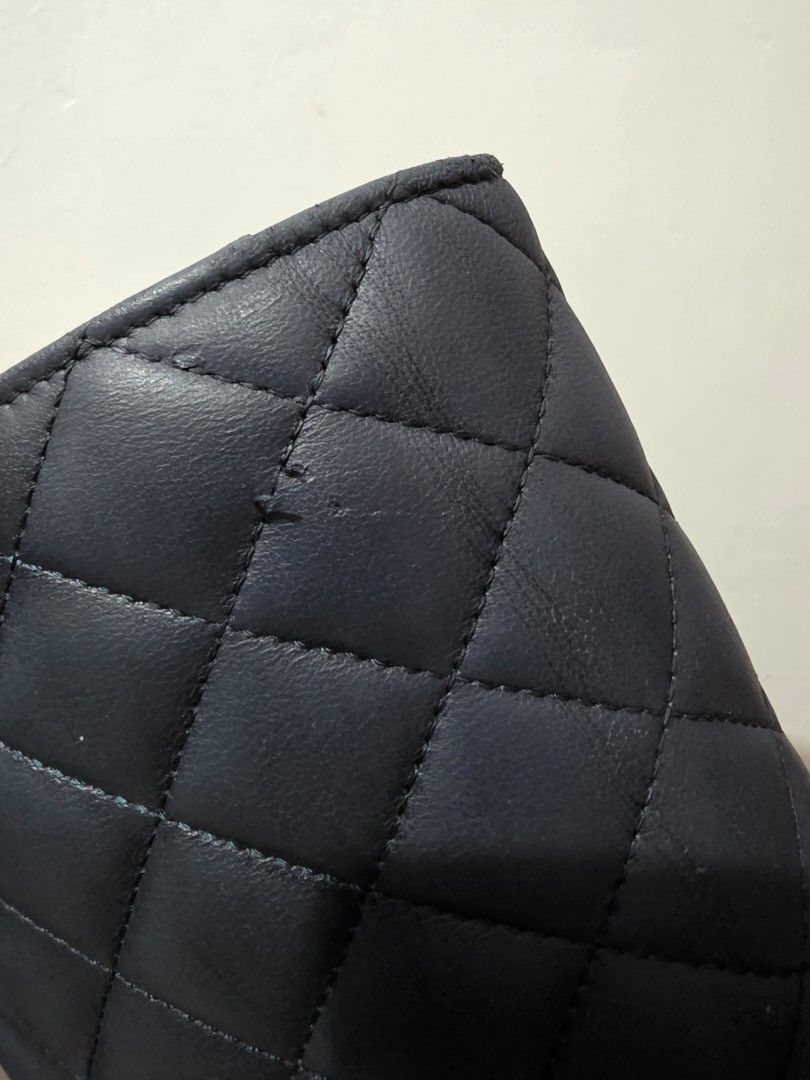 Chanel Quilted Leather Chain Wallet Bag (Category: Luxury Bags & Wallets) located in Lemery. Submitted by venus23 (Listing ID 1467167820, Image 3). Description: - Brand: Chanel - Color: Dark Blue & Black - Hardware: Silver-tone CC hardware - Material: Quilted and smooth leather - Strap: Intertwined leather and chain shoulder strap - Features: Classic diamond quilting pattern, circular clasp design, compact size for daily essentials - Condition: G