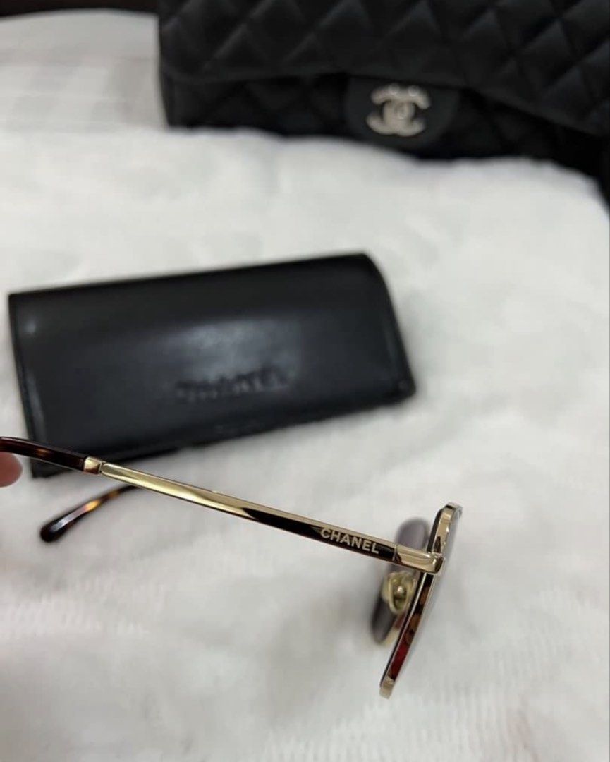 Chanel Square Gold Sunglasses with Case (Category: Sunglasses & Eyewear) located in Manila. Submitted by kai.168 (Listing ID 1467163569, Image 3). Description: - Authentic Chanel square sunglasses - Gold metal frame with gradient dark brown lenses - Subtle Chanel branding on lens and gold lettering on temples - Tortoise shell pattern at ear tips and CC-stamped nose pads - Includes original black leather hard case with embossed logo.