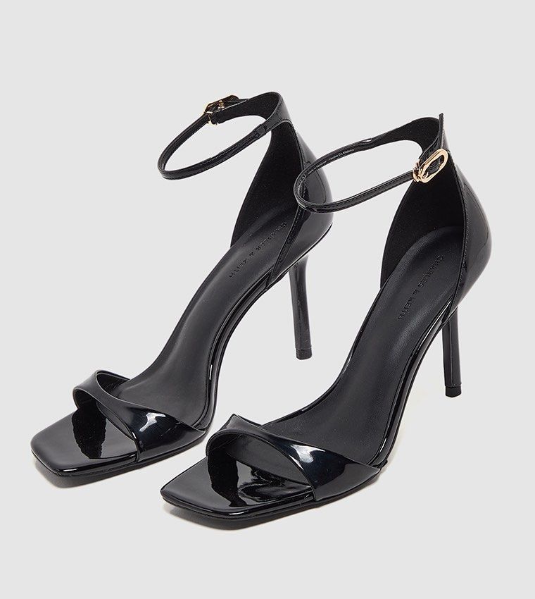 Charles & Keith Black Patent Heels (Category: Heels) located in Quezon City. Submitted by jo216 (Listing ID 1467124480, Image 1). Description: - Brand: Charles and Keith - fits size 5 & thin size 6 feet max - Material: Black patent leather - Design: Square toe with thin ankle strap and gold-tone buckle - Heel: High stiletto - Condition: Clean insoles and pristine outer finish.