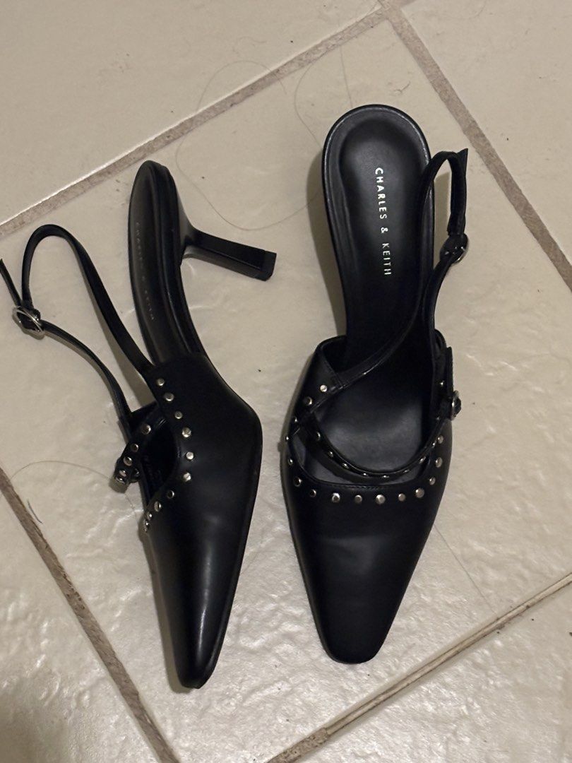 Charles & Keith Black Studded Kitten Heels (Category: Heels) located in Manila. Submitted by cosmic.chalkstripes (Listing ID 1467149256, Image 2). Description: - Brand: Charles & Keith - Color: Classic Black - Style: Pointed toe slingback kitten heels with silver stud accents - Fit: Adjustable metal buckle strap - Condition: Excellent, sole stickers still attached with minimal wear - RFS: size too big .
