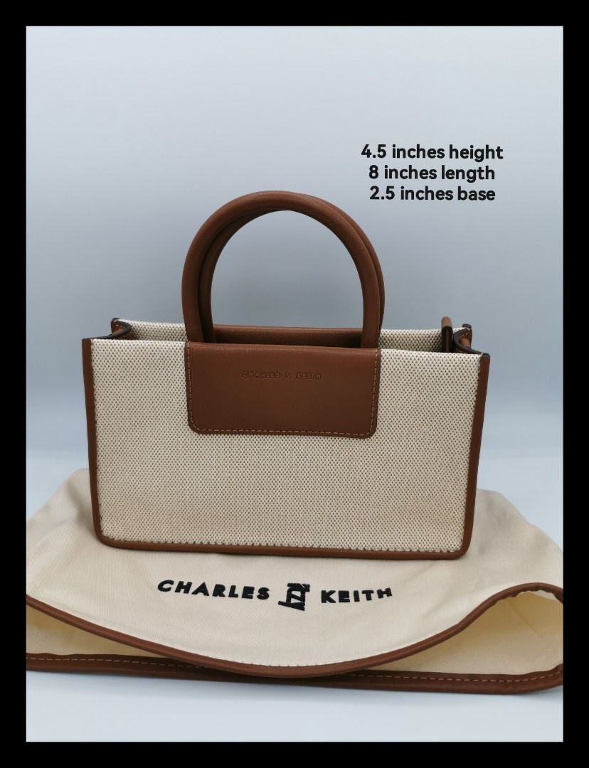 Charles & Keith Mini Astra Canvas Tote Bag (Category: Tote Bags) located in Malabon City. Submitted by restrapped88 (Listing ID 1467145839, Image 1). Description: - Brand: Charles & Keith from the collection IT'Z MINE - Inclusions: Comes with original dust bag - Material: Beige canvas with tan brown leather trim - Dimensions: 8" (Length) x 4.5" (Height) x 2.5" (Base width).