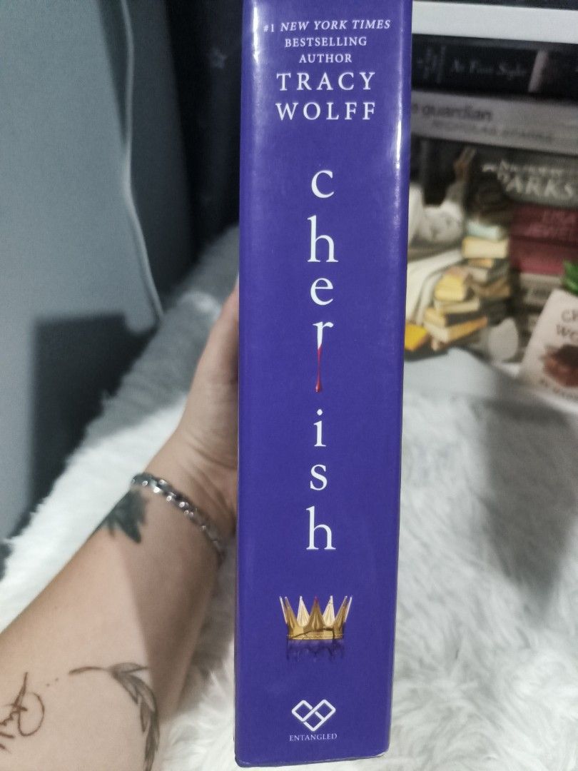 Cherish by Tracy Wolff Hardcover Novel (Category: Storybooks) located in Cabuyao City. Submitted by chaptersandwonders143 (Listing ID 1467010610, Image 3). Description: Condi: may minimal tear sa dust jacket - Title: Cherish by Tracy Wolff (Hardcover Bestseller) - Edition: Walmart Exclusive with special bonus content sticker - Design: Stunning purple cover with gold foil spine accents and crown detail - Condition: Brand new, clean pages, and tigh