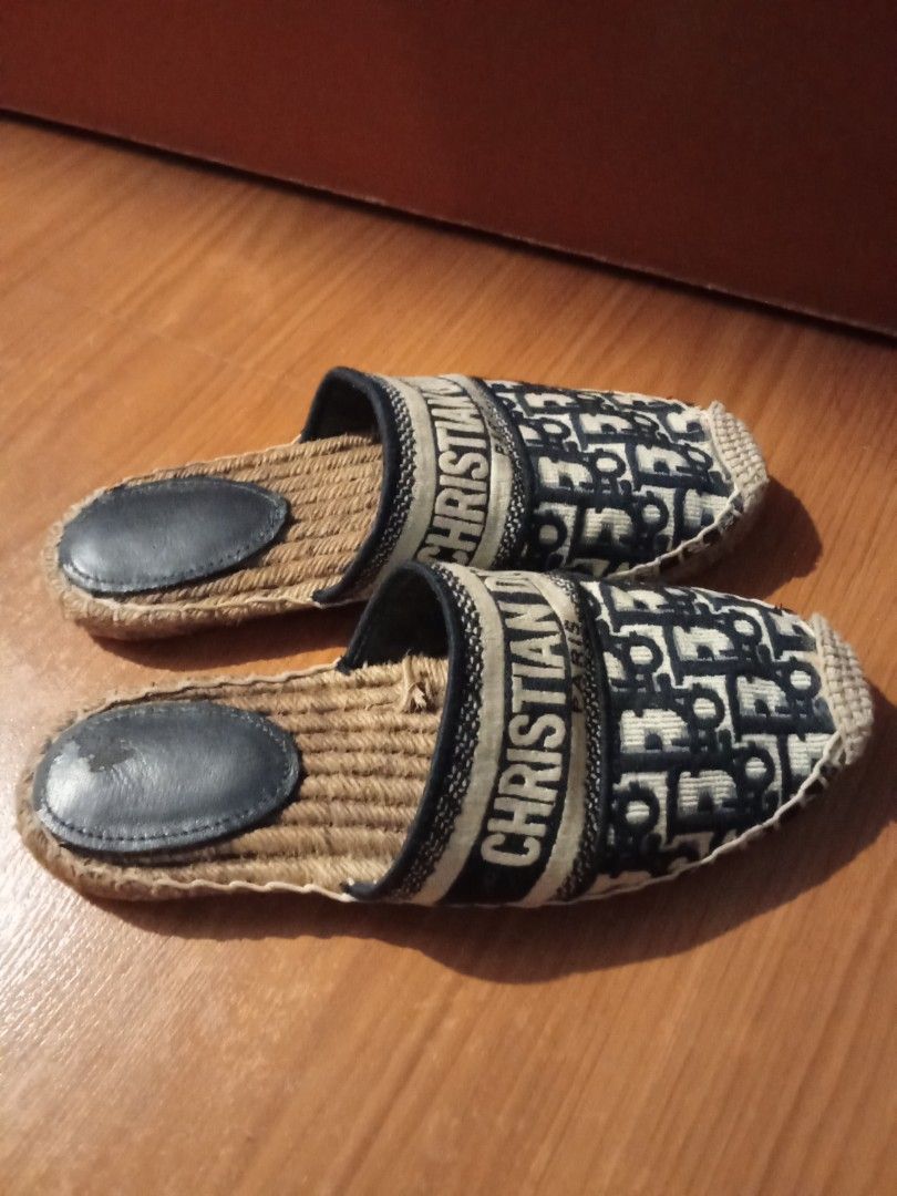 Christian Dior Paris Oblique Mules Slides (Category: Sneakers & Footwear) located in Las Pinas. Submitted by Gienuine (Listing ID 1467046980, Image 3). Description: - Authentic Christian Dior Paris embroidered mules - Classic navy blue Oblique monogram pattern with signature band - Comfortable slip-on design with woven jute sole - Dark leather heel pad with minor scuffs from gentle wear - Clean fabric upper and structured toe, well-maintained ove