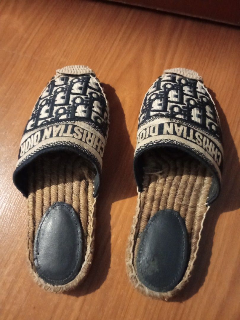 Christian Dior Paris Oblique Mules Slides (Category: Sneakers & Footwear) located in Las Pinas. Submitted by Gienuine (Listing ID 1467046980, Image 2). Description: - Authentic Christian Dior Paris embroidered mules - Classic navy blue Oblique monogram pattern with signature band - Comfortable slip-on design with woven jute sole - Dark leather heel pad with minor scuffs from gentle wear - Clean fabric upper and structured toe, well-maintained ove